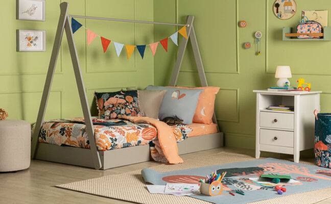 quarto infantil montessoriano com cama, mesa de cabeceira, tapete e outros itens decorativos